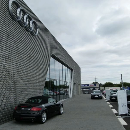 An audi dealership showcasing cars with steel manufacturers involved in metal solutions.
