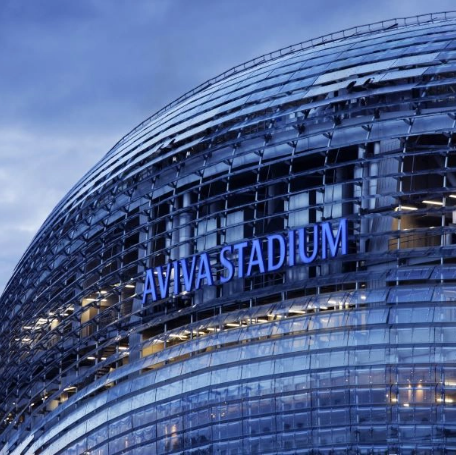 A stadium with a blue sign on it made of metal sheets.