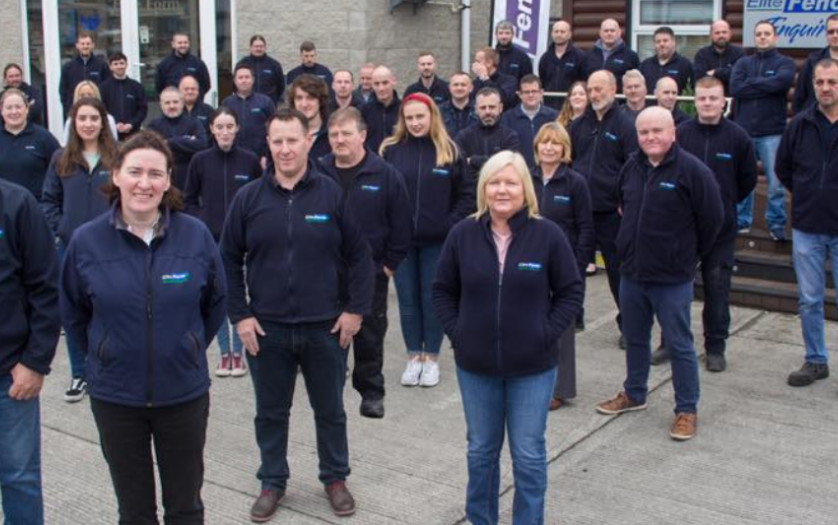 A group of steel manufacturers and metal solutions experts standing in front of a building.