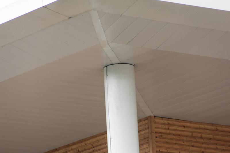 A close up of a white building with a white pole showcasing metal solutions.