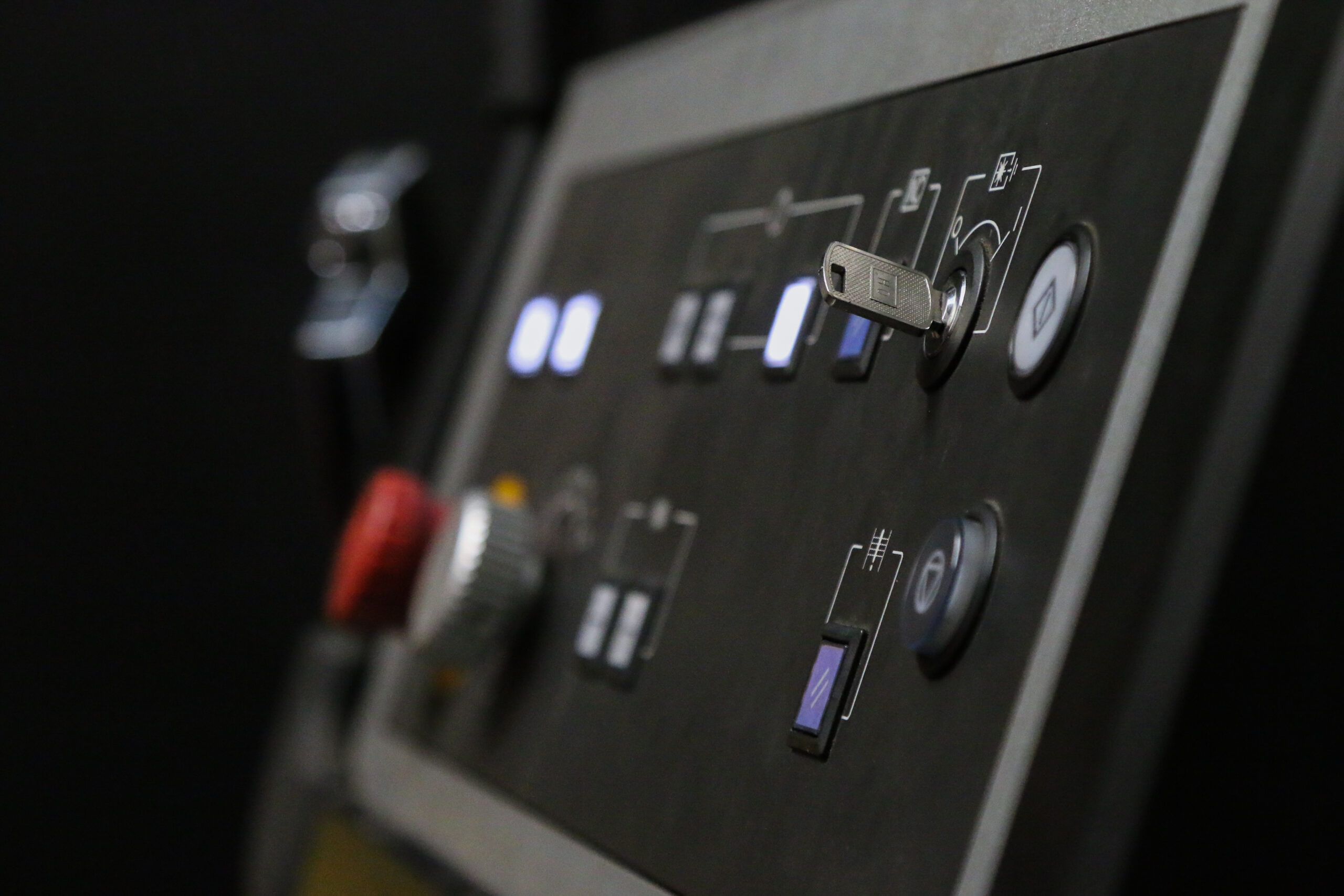 A close up of a machine control panel featuring metal sheets.